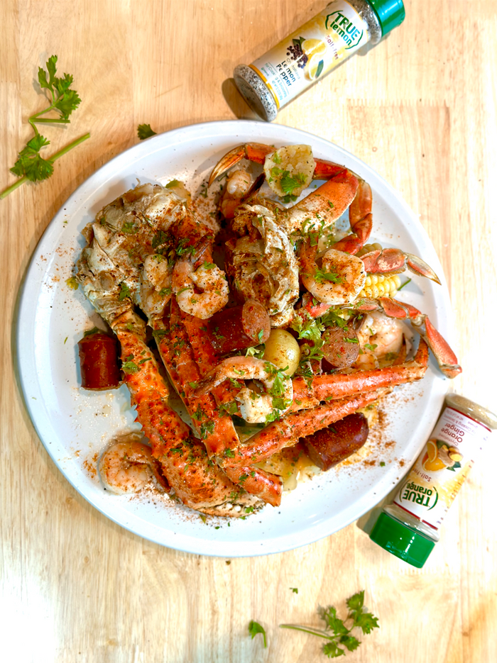 Picture of seasoned seafood on a plate with True Lemon seasoning blends.
