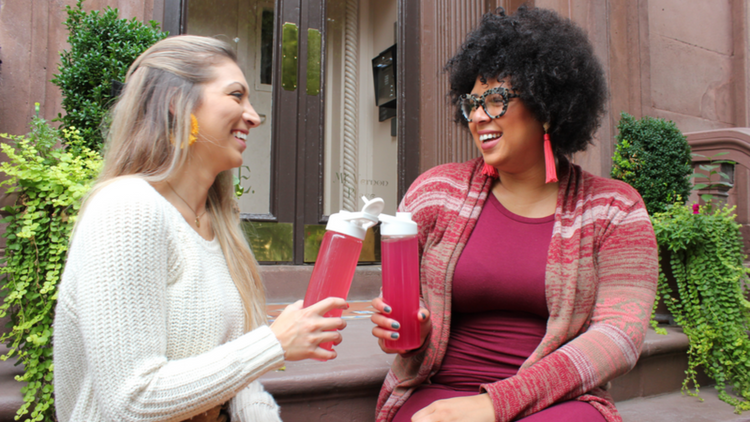 Two women celebrating fall and drinking True Lemon lemonade. 