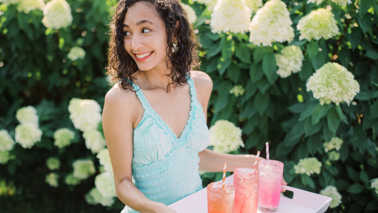 woman holding glasses of water