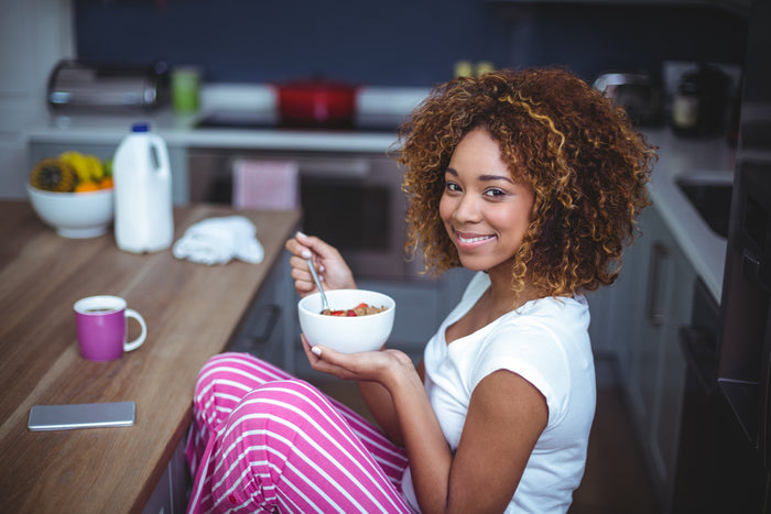 women eats oats while in her pajamas