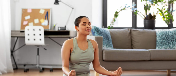 young-black-woman-meditating-yoga-at-home-self-care-wellness-tips-stay-home-staycation