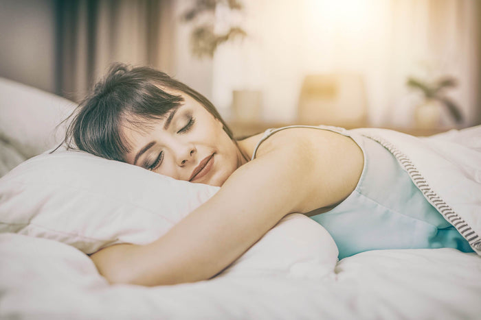 women sleeps with a pillow in her bed