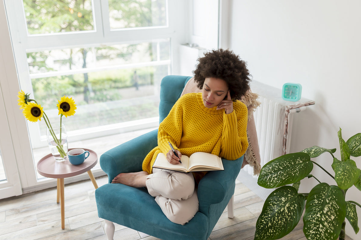 a woman writing in a journal