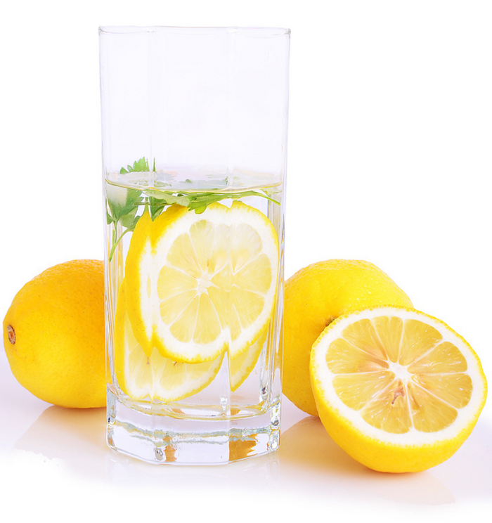 Glass of lemon water with white background