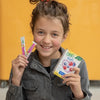A young girl holds up a box of True Lemon Kids Blue Raspberry and smiles.